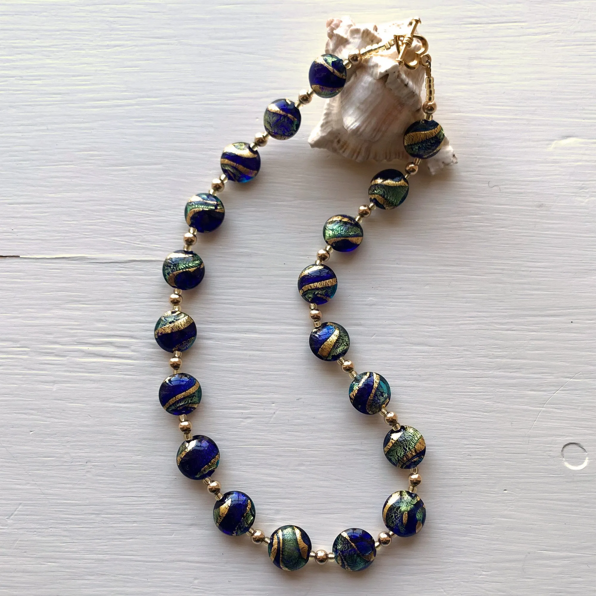 Necklace with dark blue (cobalt) teal gold swirl Murano glass small lentil beads on gold